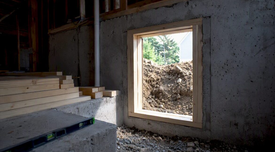 Basement wall with framed egress window opening