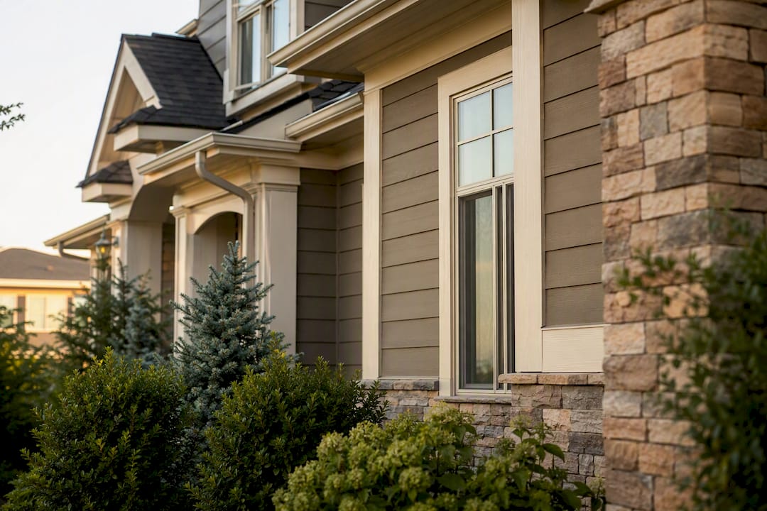 Sandy khaki siding with cream trim on house exterior