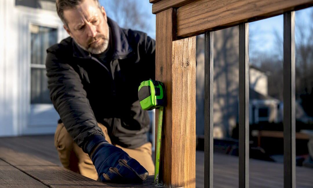 Inspector measuring residential deck railing height