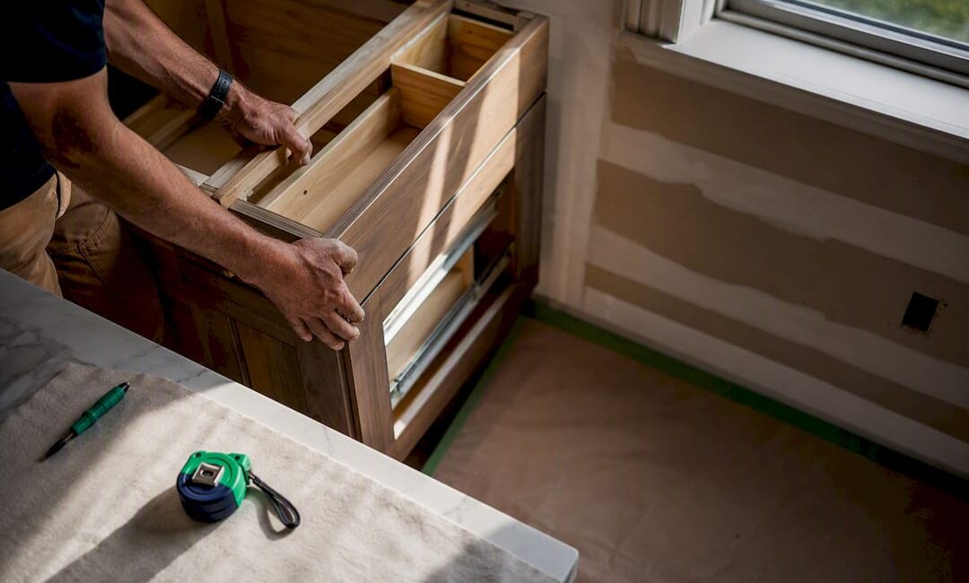 Contractor aligning cabinetry during kitchen remodel