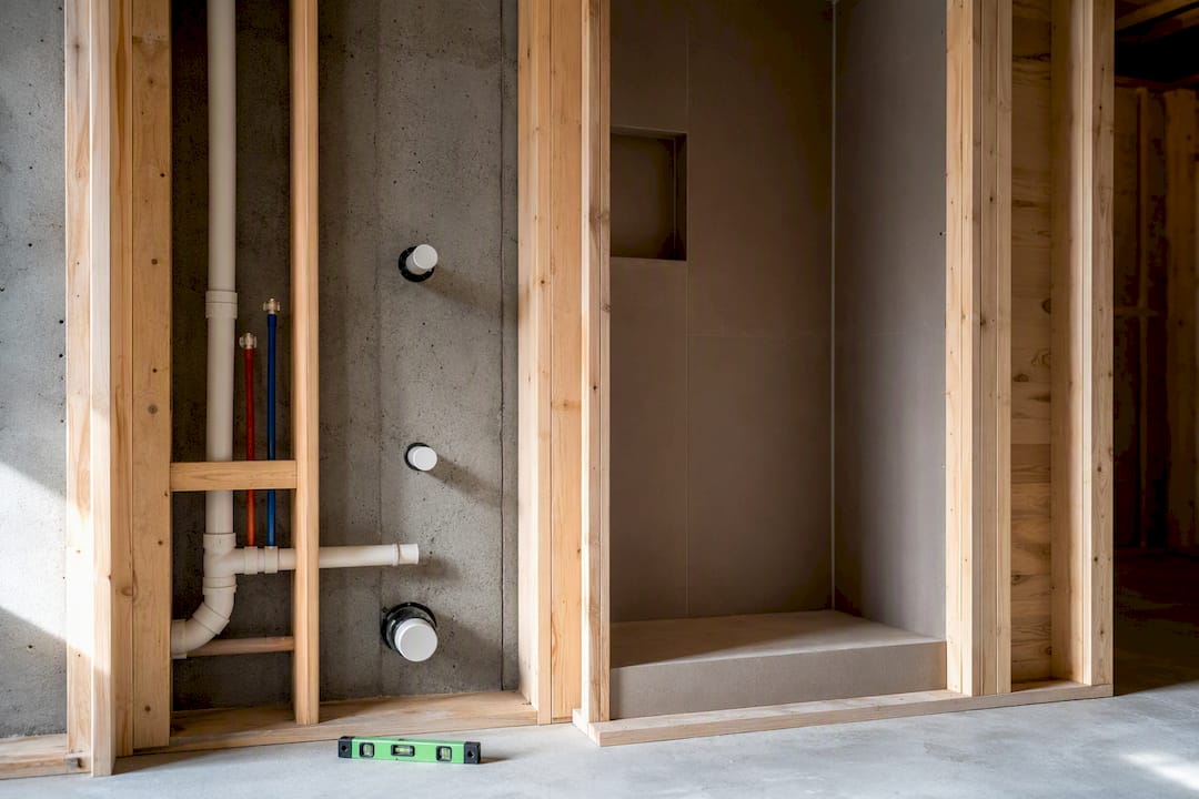 Capped plumbing stubs in framed basement bathroom