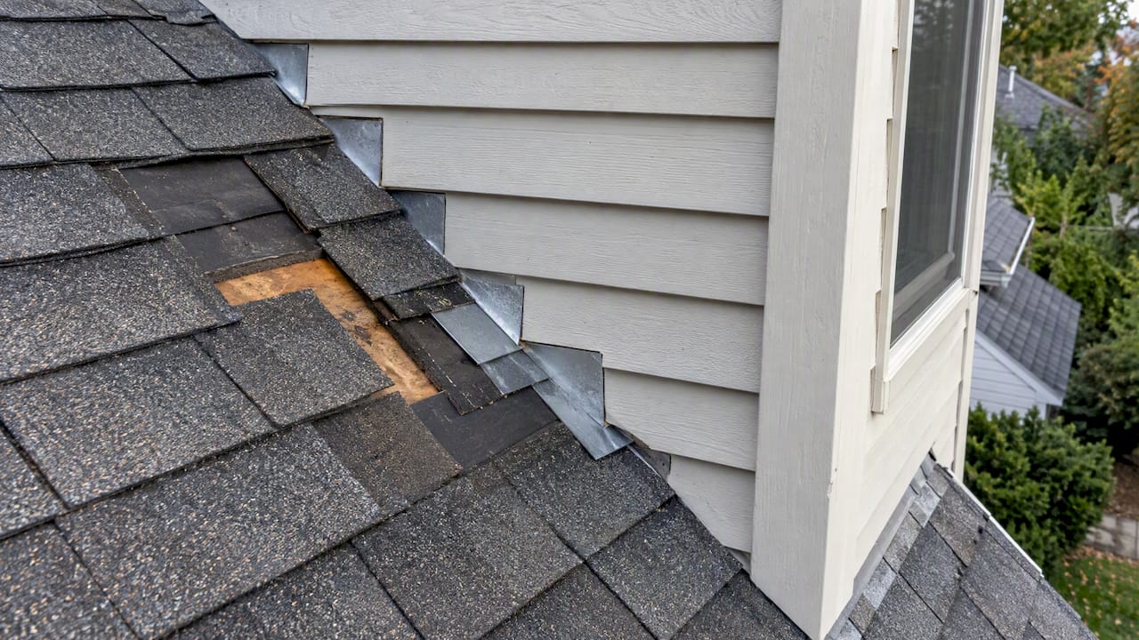 Step flashing at a dormer roof junction