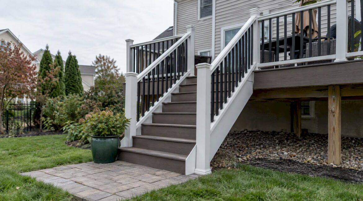 Composite deck stairs meeting a paver landing